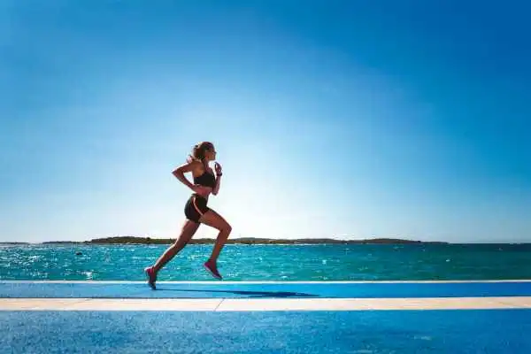 Woman running showing strong leg muscle West End
